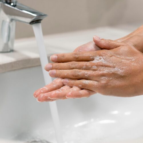 person washing hands close up